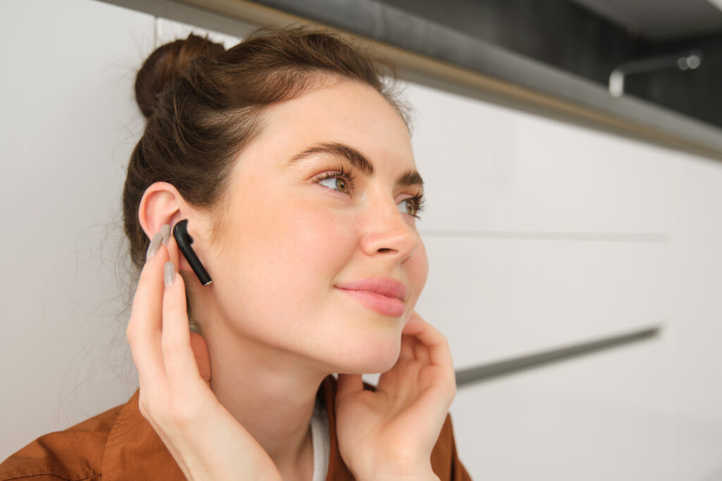 Image of a woman wearing Ear Buds